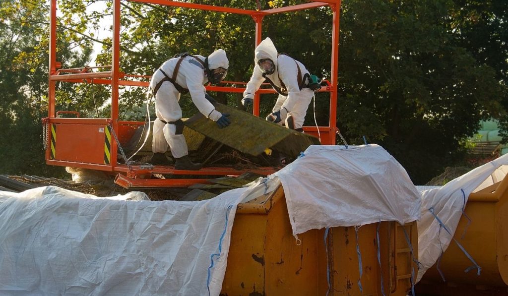 men in white suits removing asbestos